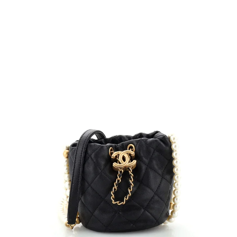 Vintage - style bucket bag with a brass clasp and leather strapsAbout Pearls Bucket Bag Quilted Calfskin Mini