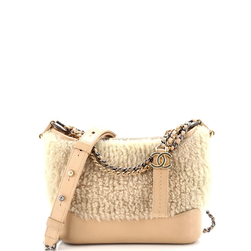 Faux fur hobo bag with a fluffy texture for a winter fashion statementGabrielle Hobo Shearling and Leather Small