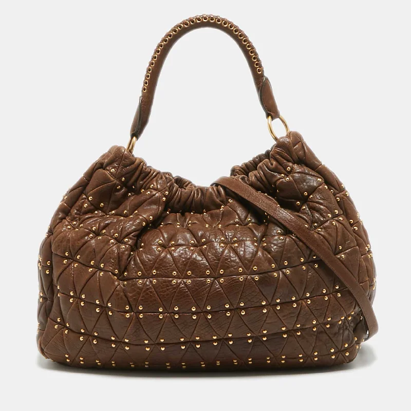 Vintage - inspired hobo bag with a brass frame and tassel detailsMiu Miu Dark Brown Matelasse Leather Studded Hobo