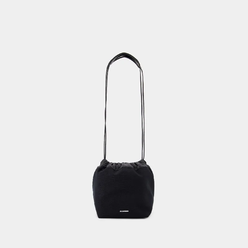 Hobo bag with a magnetic snap closure for easy accessDumpling Shoulder Bag - Jil Sander - Leather - Black