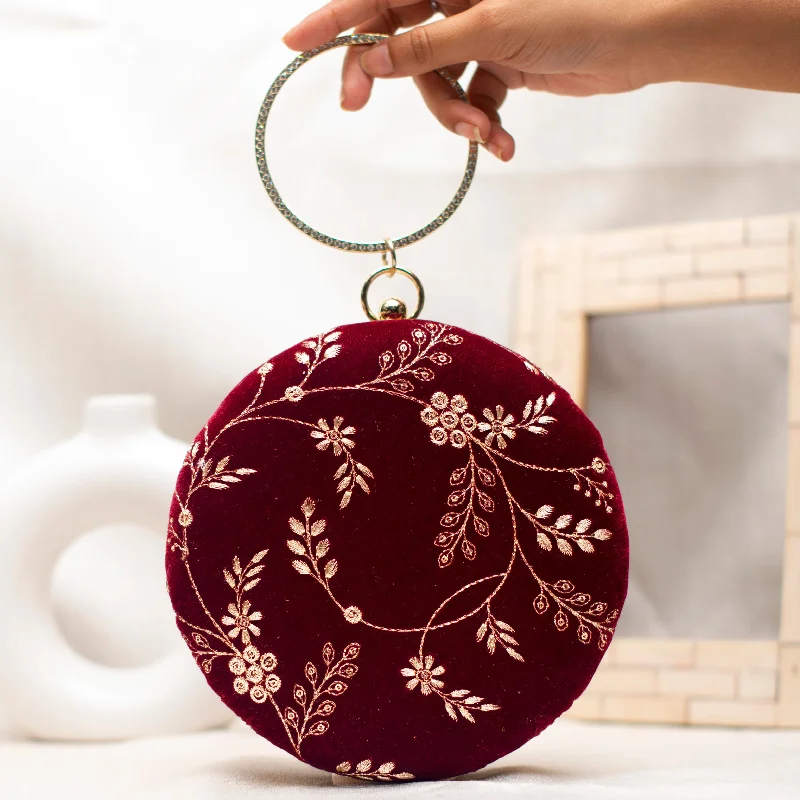 Velvet clutch with a tassel detail for a bohemian - chic styleMaroon And Golden Embroidery Round Clutch