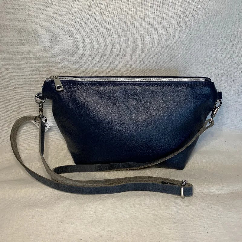 Metallic crossbody bag with a glittery finish for evening partiesNavy blue leather mini crossbody with interior zipper pockets. Metallic crossbody bag with a glittery finish for evening partiesNavy blue leather mini crossbody with interior zipper pockets.