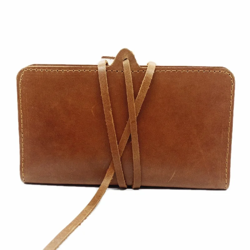 Clutch with a removable strap to be used as a hand - held or cross - bodyPICKA WALLET: Brown