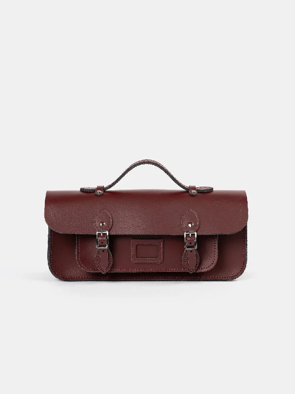 Leatherette handle bag with a quilted diamond pattern and a magnetic snap closureThe Long Satchel - Oxblood